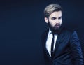 young attractive bearded hipster man gesturing emotional screaming in studio sucsess. fashion modern brutal guy Royalty Free Stock Photo