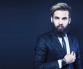 young attractive bearded hipster man gesturing emotional screaming in studio sucsess. fashion modern brutal guy Royalty Free Stock Photo