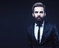 young attractive bearded hipster man gesturing emotional screaming in studio sucsess. fashion modern brutal guy Royalty Free Stock Photo