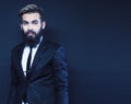 young attractive bearded hipster man gesturing emotional screaming in studio sucsess. fashion modern brutal guy Royalty Free Stock Photo