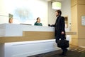 Young attractive bearded man cheking in the hotel Royalty Free Stock Photo