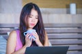 Young attractive and beautiful 20s Asian Chinese woman lying on bed at night using internet in laptop computer watching movie or w Royalty Free Stock Photo