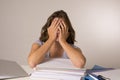 Young attractive and beautiful tired student girl leaning on school books pile sleeping tired and exhausted after studying Royalty Free Stock Photo