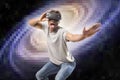 Young attractive black afro American man using vr virtual reality 3D goggles playing space travel videogame with pixelated compute