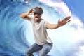 Young attractive black afro American man using vr virtual reality 3D goggles playing surf videogame with pixelated computer sea wa Royalty Free Stock Photo