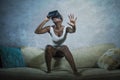 Young attractive curious black afro american woman wearing VR 3d vision goggles enjoying amazing experience playing and having fun Royalty Free Stock Photo