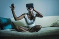 Young attractive curious black afro american woman wearing VR 3d vision goggles enjoying amazing experience playing and having fun Royalty Free Stock Photo