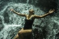 Young attractive and blissful Asian Indonesian woman overwhelmed by the beauty of natural waterfall in tropical jungle enjoying Royalty Free Stock Photo