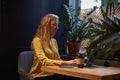 young attractive blond cauasian woman sitting at coffe shop, working on laptop