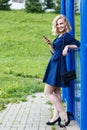 Young attractive blond woman in a summer park