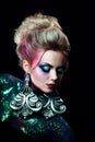 Young attractive blonde girl in bright art-makeup, high hair, body painting. Rhinestones and glitter Royalty Free Stock Photo