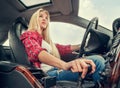 Young attractive blonde girl driving a car with an automatic gear box Royalty Free Stock Photo