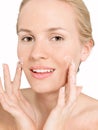 Young attractive blonde woman Applying Facial Cream Royalty Free Stock Photo