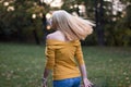 Young blonde woman dancing in the park, turning around Royalty Free Stock Photo