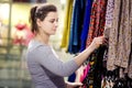 Young attractive brunette girl chooses clothes in trendy boutique. woman is buying new clothes. Shopaholic in the store Royalty Free Stock Photo