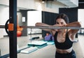 Young attractive brunette girl enlacing her sport shoes after practicing workout and crossfit training on blue yoga mat. Royalty Free Stock Photo