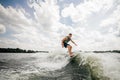 Young attractive brunette man riding on the wakeboard Royalty Free Stock Photo