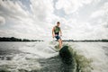 Young attractive brunette man riding on the wakeboard Royalty Free Stock Photo