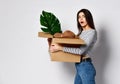 Young woman holding box with things.