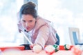 Young attractive brunette woman playing billiards pool game Royalty Free Stock Photo