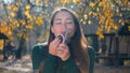 Young attractive brunette woman sniffing a pack of money and savour