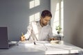 Young attractive business man in white shirt working at the desk on his workplace at the office. Royalty Free Stock Photo