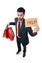 Young attractive business man in stress holding lot of shopping bags and help sign looking tired bored and worried Royalty Free Stock Photo