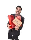 Young attractive business man in stress holding lot of shopping bags and showing help sign tired bored and worried