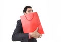 Young attractive business man in stress holding shopping bag looking greedy after buying bargain Royalty Free Stock Photo