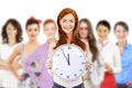 Young attractive business woman holding clock