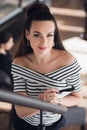 Young attractive business woman with long straight hair holds a notebook or job interview in a coffee-shop or cafe Royalty Free Stock Photo