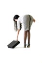 Young attractive business woman picking attache case up off floor Royalty Free Stock Photo