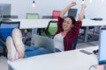 Young attractive business woman in red and black shirt enjoying alone at her office Royalty Free Stock Photo