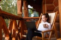 Young attractive business woman is working on the laptop at mountain resort with a cup of tea and cookie. Female relaxes Royalty Free Stock Photo