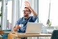 Young attractive businessman drinking coffee and looking at his computer. - Image