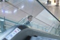 Young handsome businessman going down on an escalator and looking up Royalty Free Stock Photo