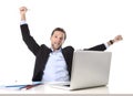 Young attractive businessman happy and hectic at office work sitting at computer desk satisfied celebrating Royalty Free Stock Photo