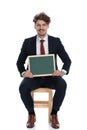 Young attractive businessman presenting his board at camera Royalty Free Stock Photo