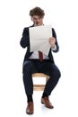 Young attractive businessman reading the newspaper and being shocked Royalty Free Stock Photo