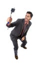 Young attractive businessman in suit and tie taking selfie photo with mobile phone camera and stick posing happy Royalty Free Stock Photo