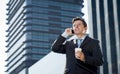 Young attractive businessman in suit and tie talking on mobile phone happy outdoors Royalty Free Stock Photo