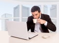 Young attractive businessman working at business district office sitting at computer desk drinking coffee Royalty Free Stock Photo