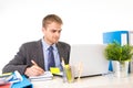 Young attractive businessman working busy with laptop computer at office desk smiling looking satisfied Royalty Free Stock Photo