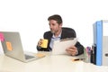 Young attractive businessman working happy confident at office reading file drinking coffee Royalty Free Stock Photo