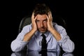 Young attractive businessman in worried tired and stressed face expression sitting depressed on office chair Royalty Free Stock Photo