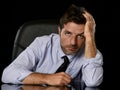 Young attractive businessman in worried tired and stressed face expression sitting depressed on office chair Royalty Free Stock Photo