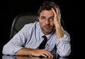 Young attractive businessman in worried tired and stressed face expression sitting depressed on office chair Royalty Free Stock Photo