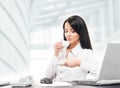 Young and attractive businesswoman drinking morning coffee