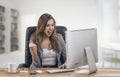 Young attractive businesswoman expressing success at office Royalty Free Stock Photo