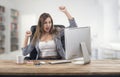 Young attractive businesswoman expressing success at office